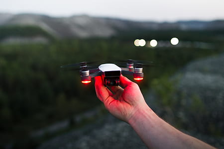 person holding white drone thumbnail