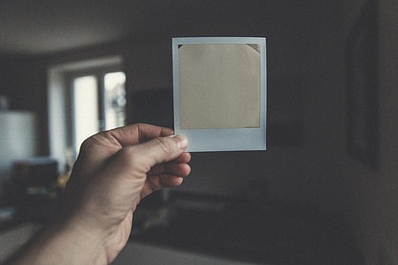 person holding white and gold card thumbnail