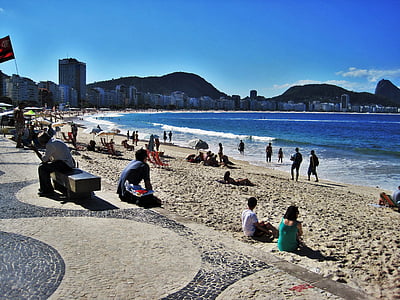 people gathered at brown sand beach thumbnail