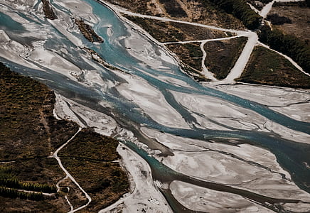 water flowing through area in between forest thumbnail