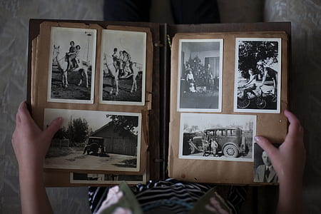 person holding photo album thumbnail