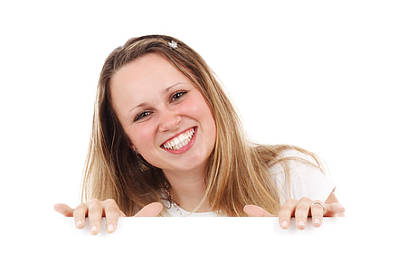 woman in tan crewneck shirt smiling thumbnail
