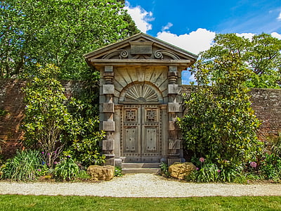 brown wooden door with red bricked wall thumbnail