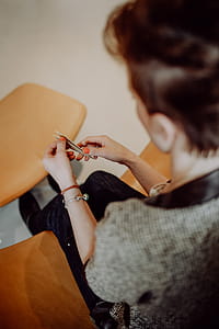 Women folding sheet of paper while making origami thumbnail
