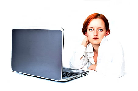 woman in white dress shirt sitting in front of black laptop thumbnail
