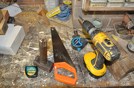 black and yellow DEWALT cordless power drill near orange and black wood saw thumbnail