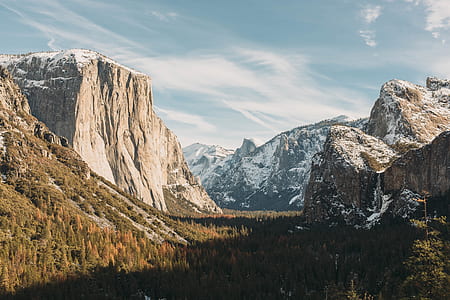mountain covered with snow under cloudy sky thumbnail
