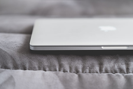 Closed Macbook Laptop on a Sofa thumbnail