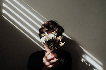 man holding white flowers thumbnail