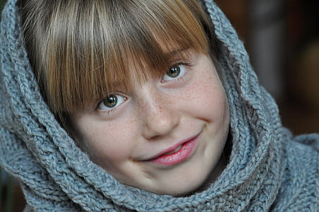 smiling girl wearing grey knitted scarf thumbnail