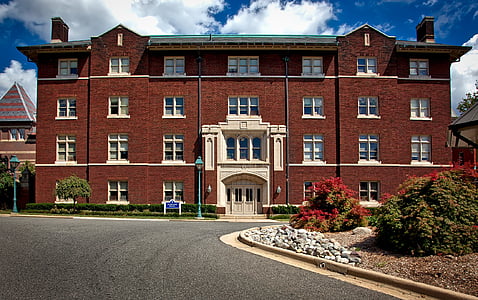 brown 4-storey concrete building during daytime thumbnail