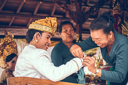 Woman Tying String on Man's Sleeve thumbnail