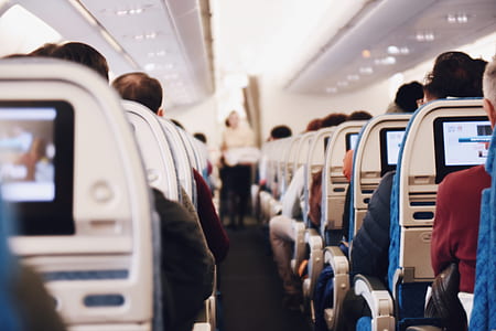 people sitting on airplane chairs thumbnail