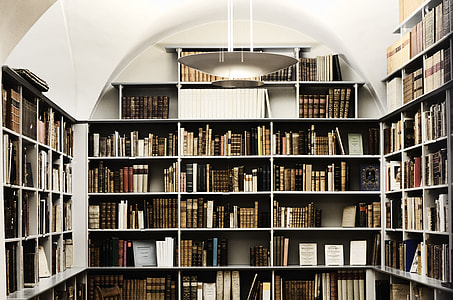 assorted-title books placed on white wooden shelves thumbnail