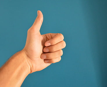 person's left hand doing hand gesture thumbnail