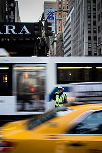 police officer standing near yellow car during daytime thumbnail