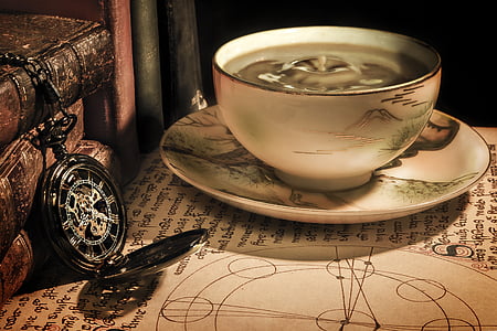 brown pocket watch and round white ceramic bowl with saucer thumbnail