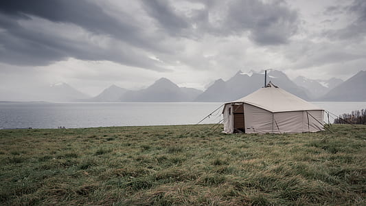 white canopy tent in the middle of grass field thumbnail