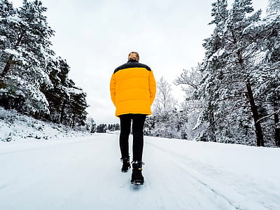 selective color photography of man walks on snow pavement thumbnail
