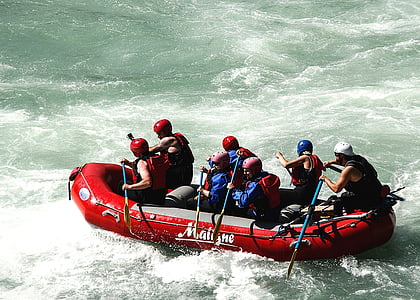 people on red inflatable boat on body of water at daytime thumbnail