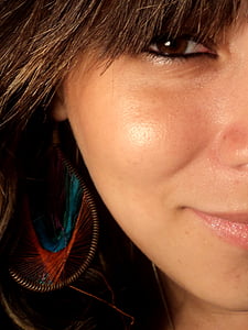 woman wearing brown and green dangle earring thumbnail