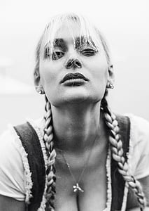 woman wearing white scoop-neck shirt and silver-colored earrings with hair bangs thumbnail