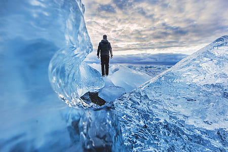 person wearing gray hoodie and black pants standing on ice thumbnail
