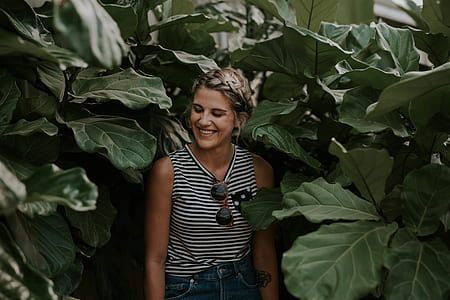 woman standing and surrounded by plants thumbnail