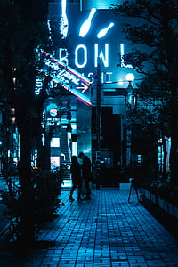 man and woman standing in front of bowl building thumbnail