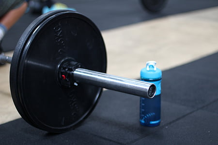 close-up photo of black barbell beside blue sports bottle thumbnail