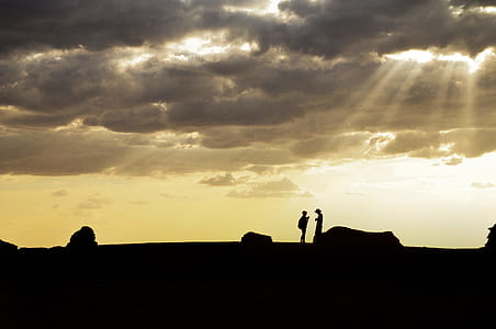 Silhouette of Two People Standing on High Ground thumbnail