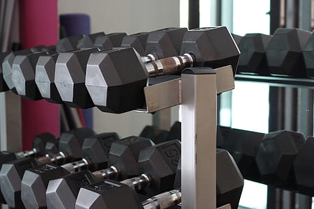 dumbbells on white rack thumbnail