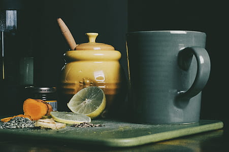 gray ceramic mug beside yellow and brown ceramic jar thumbnail