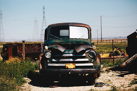 wrecked brown car near electric post thumbnail