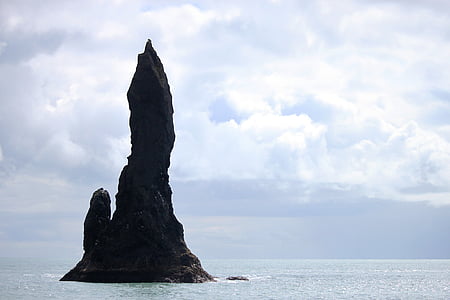 photo of island near body of water during daytime thumbnail