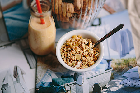 Jar full of walnuts with a fresh healthy shake and musli in a bowl thumbnail
