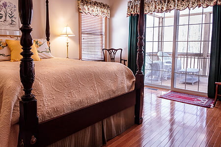 brown wooden bed frame and white bed mattress thumbnail