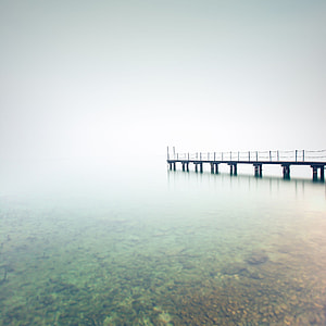 black wooden jetty on body of water thumbnail