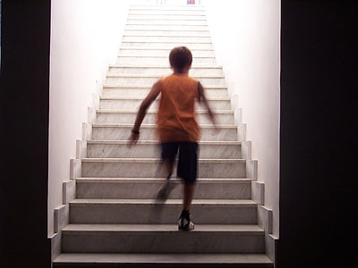 boy walking on gray stair thumbnail