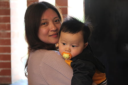 woman carrying baby thumbnail