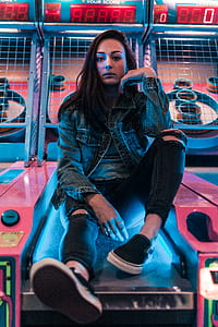 woman sitting on basketball hoop arcade thumbnail