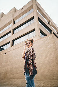 woman standing in front of building at during daytime thumbnail