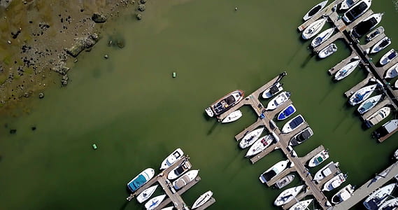 aerial photography of parked boats on body of water near dock thumbnail
