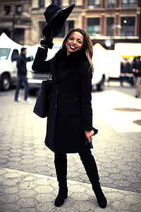 woman standing on street during daytime thumbnail