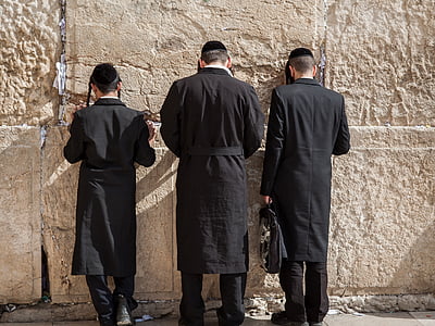 three men in black suit standing near gray concrete wall thumbnail