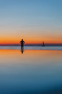 The man is looking at the sunset by the sea thumbnail