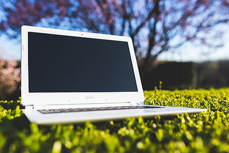 white Acer laptop on grass field thumbnail