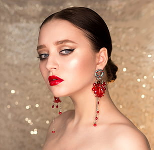 woman wearing red chandelier earrings thumbnail