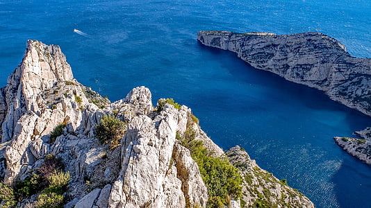 body of water beside mountain thumbnail