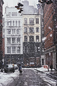 person walking on road near buildings thumbnail